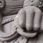 One of the many stone guardians surrounding Tirta Empul.