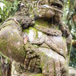 One of the many stone guardians surrounding Tirta Empul.