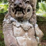 One of the many stone guardians surrounding Tirta Empul.