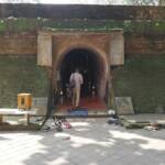 man standing at tunnel opening