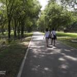 Man and woman walking on an empty road