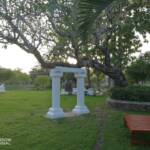 Bell suspended on white pillars
