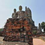 Buddha statues seated on pedestals