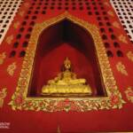 The walls of the temple have small Buddhas