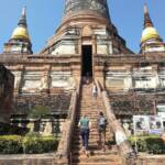 People going up the steps of Wat Yai Chai Mongkhol's main temple