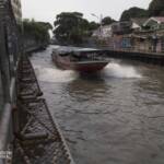 A boat speeding along a river