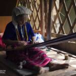 Old woman weaving in traditional medthod